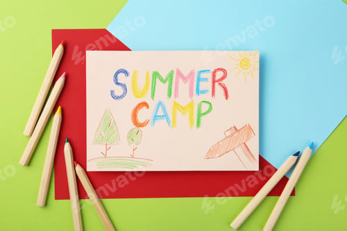 Preview: Paper with written text SUMMER CAMP, drawings and different pencils on color background, flat lay