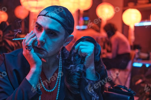 Preview: Pensive transgender sitting in nightclub