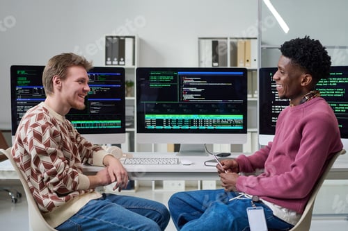 Preview: Young Men Collaborating in Office While Discussing Software Development