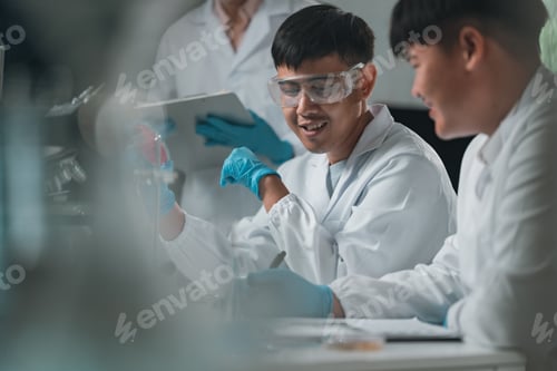 Preview: Researchers presenting scientific findings in a laboratory, discussing experimental results