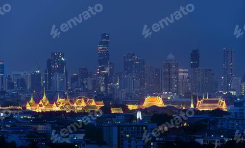 Preview: Grand Palace, Wat Pho, and skyscraper buildings. Bangkok downtown area at night, Thailand.
