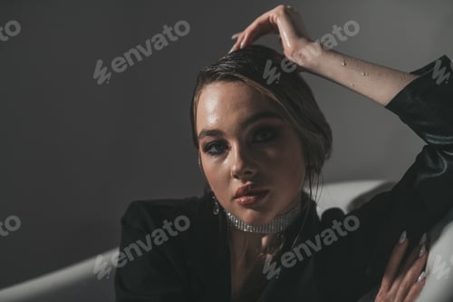 Preview: Fashion portrait candid sensual elegant sexy model girl in bra and black suit jacket at oval bathtub