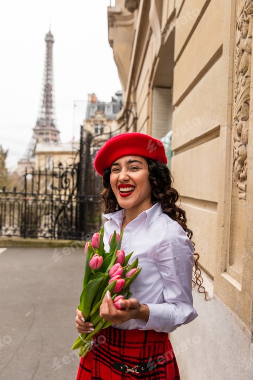 Preview: Selective focus shot of a stylish girl holding a bouquet in Paris, France