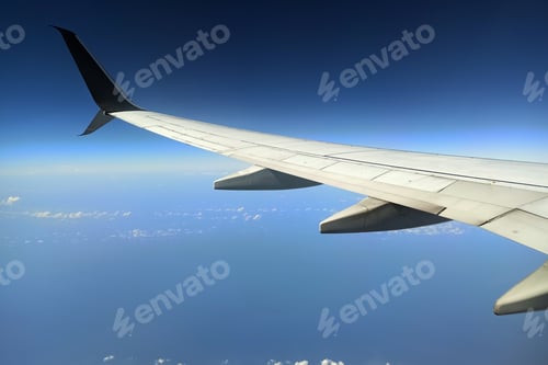 Preview: View through airplane window of commercial jet plane wing