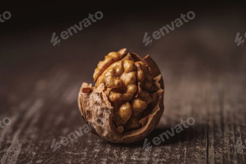 Preview: close up view of shelled walnut on wooden tabletop