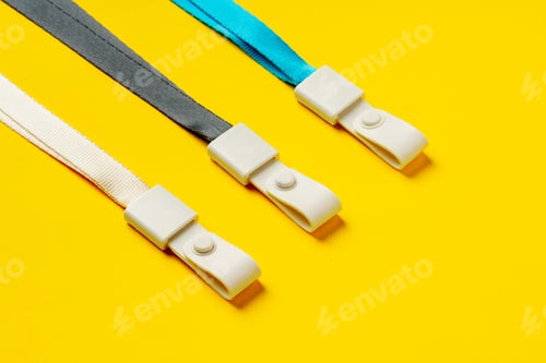 Preview: Badge strings on yellow background close up