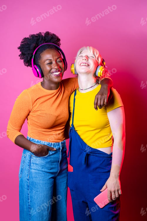 Preview: Two young diverse multicultural women best friends posing isolated background having fun