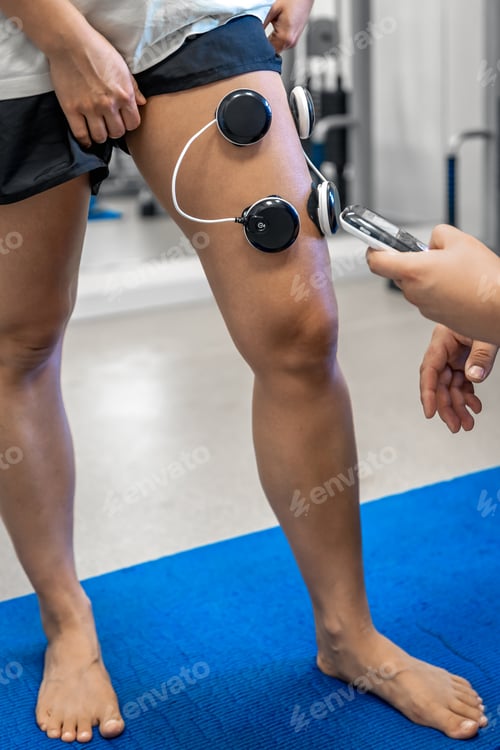 Preview: The procedure of myostimulation on the legs of a woman.