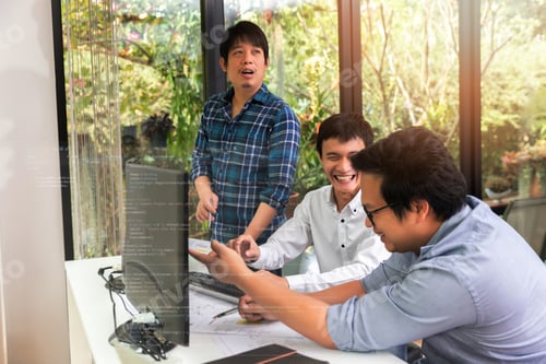 Three Men Enjoying Coding Together in Office