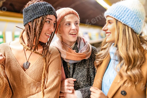 Preview: Diverse friends sharing joyful moment, winter fashion and inclusivity concept