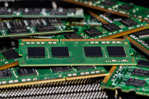 Preview: A stack of old SDRAM memory modules lying on a printed circuit board.