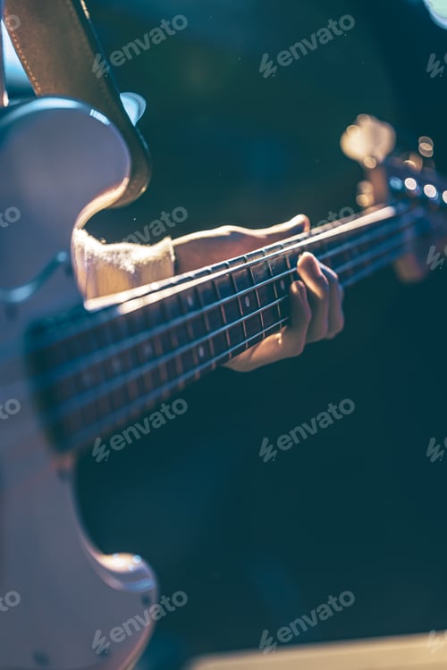 Preview: Close-up of a man playing the bass guitar.