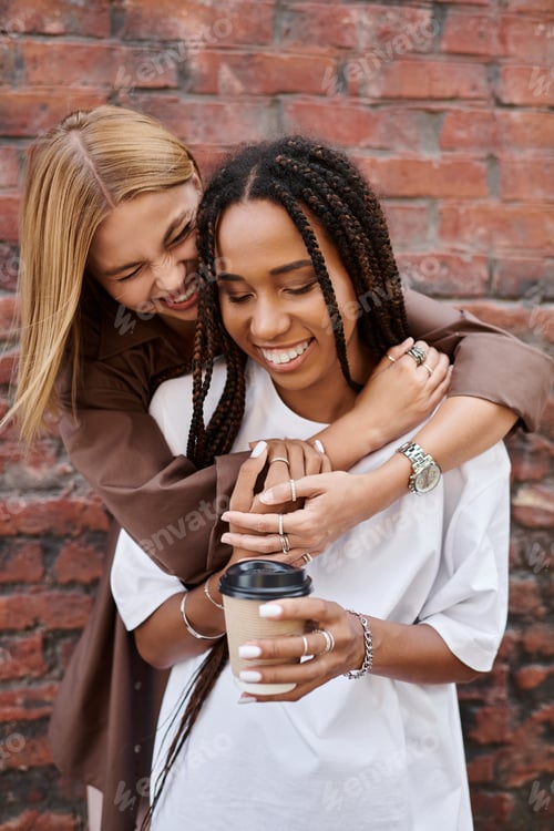Preview: A joyful multiethnic lesbian couple enjoys coffee together