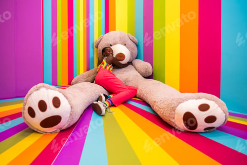 Preview: Beautiful young woman having fun inside a rainbow box room