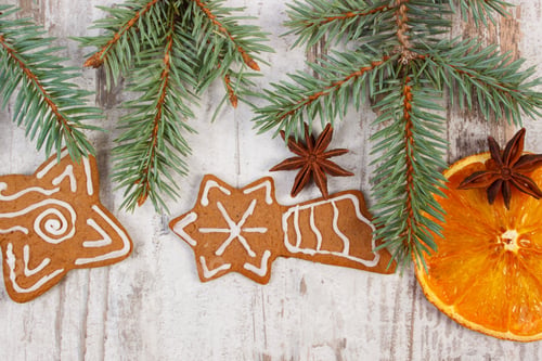 Preview: Gingerbread Cookies and Evergreen Sprigs on Rustic Background