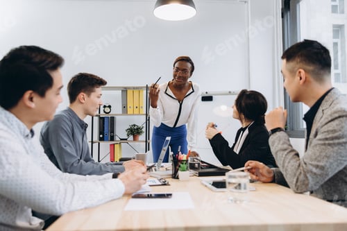 Preview: Group of multicultural businesspeople listening their boss speech