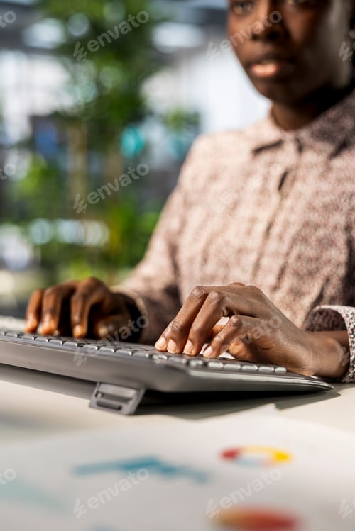 Preview: African american businesswoman managing administrative tasks at desk