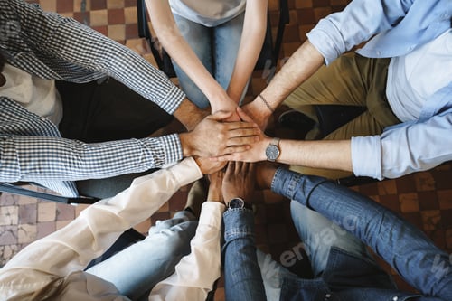 Preview: Top view of diverse people hands holding together in circle, hands stack