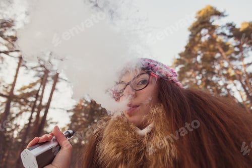 Preview: Electronic Cigarette. The Girl Smokes Electronic Cigarette.