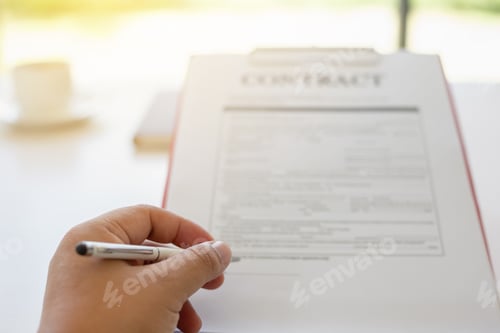 Preview: close up hand signing a contract.