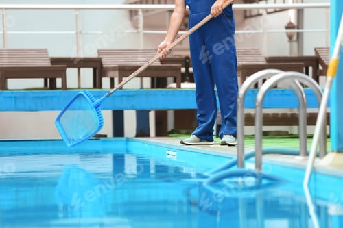 Preview: Male worker cleaning outdoor pool with scoop net