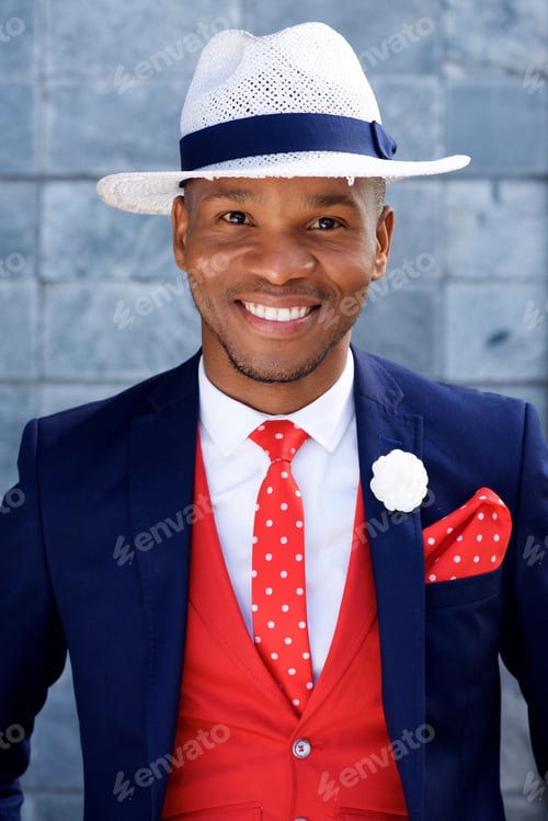 Preview: handsome young african man in suit and hat