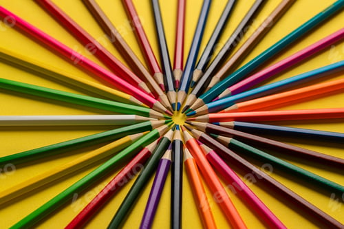 Preview: a creative idea of colorful crayons making a circle shape on the pastel background