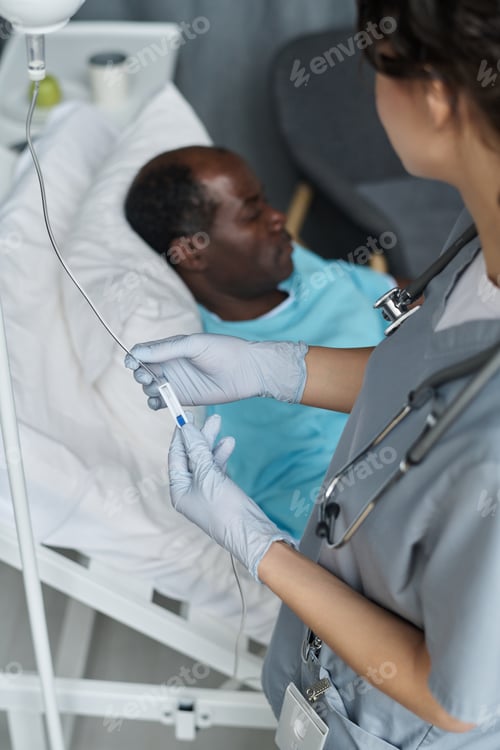 Preview: Nurse making dropper for patient