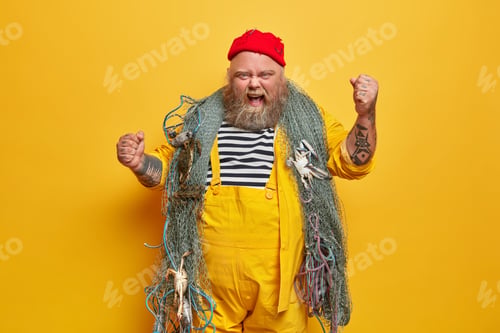 Preview: Annoyed emotional male sailor or professional seaman has sea cruise poses with fishing net raises ta