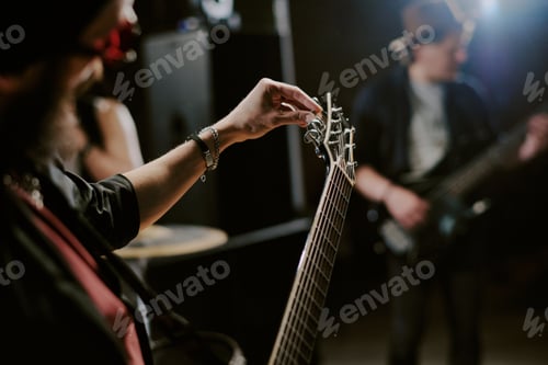Preview: Unrecognizable Guitarist Tuning His Instrument
