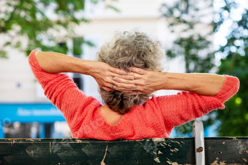 Preview: Back of middle age woman with hands behind head