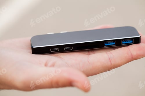 Preview: Man holding mini adapter for laptops and flash memory