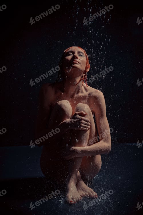 Preview: A Girl Sits On The Floor In The Rain.