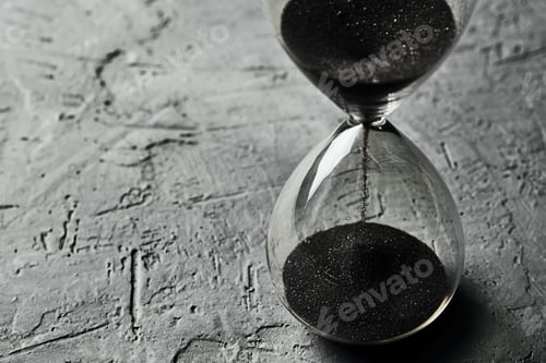 Preview: Hourglass on dark background, closeup. Urgency and running out of time concept