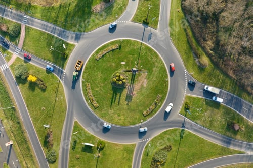 Preview: Aerial view of road roundabout intersection with moving heavy traffic.