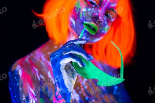 Preview: Fashion model woman in neon light, portrait of beautiful model girl with fluorescent make-up.