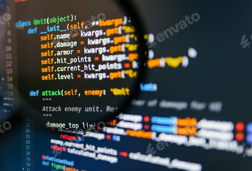 Preview: Program code on computer display in magnifying glass. Close-up