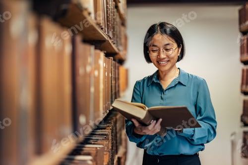 Preview: Adult asian woman with glasses, turning the pages
