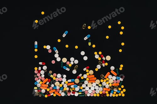 Preview: elevated view of pile colorful various pills isolated on black