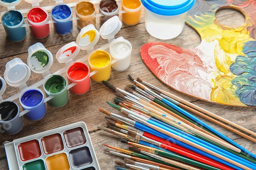 Preview: Different brushes, paints and palette on wooden background
