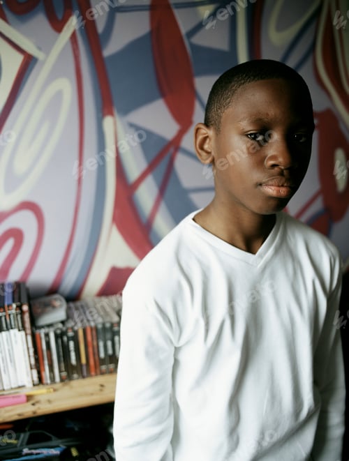 Preview: Portrait of teenage boy in bedroom