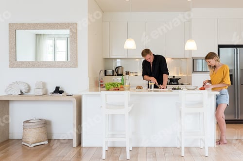 Preview: Couple making lunch on a withe kitchen at home