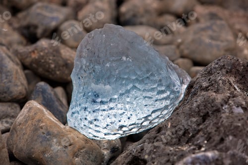 Preview: Closeup shot of a piece of ice on stones in Antarctica