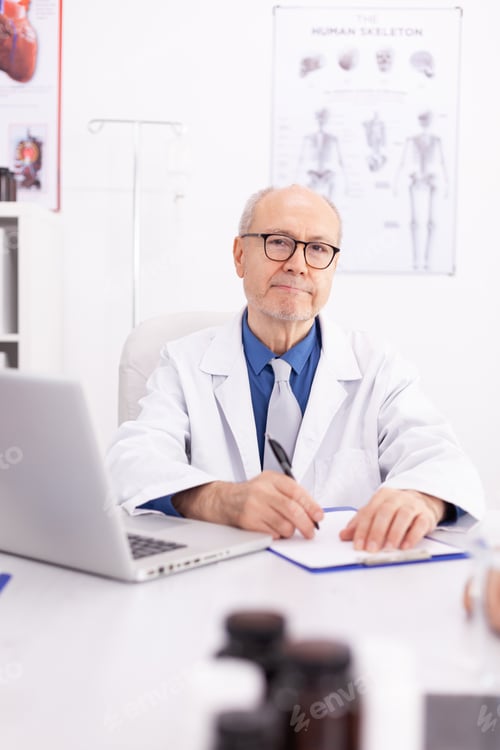 Preview: Mature doctor in hospital office