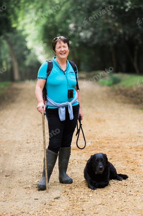 Preview: Female hiker with her dog.
