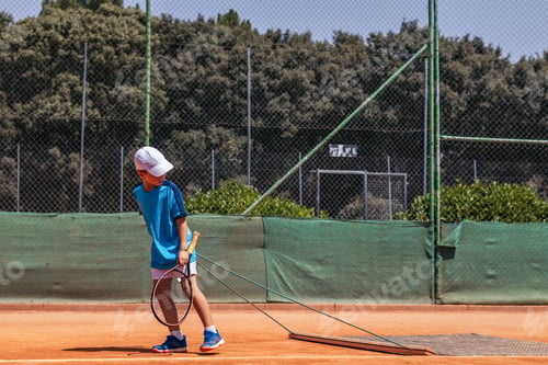 Preview: Little boy playing tennis doing court maintenance