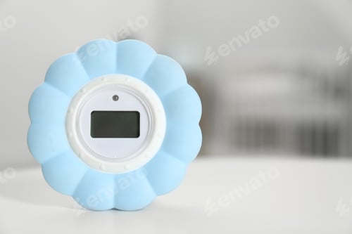 Preview: Digital temperature and humidity control in baby room interior. Space for text