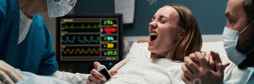 Preview: Caucasian Young Adult Woman Experiencing Labor While Holding Partner Hand