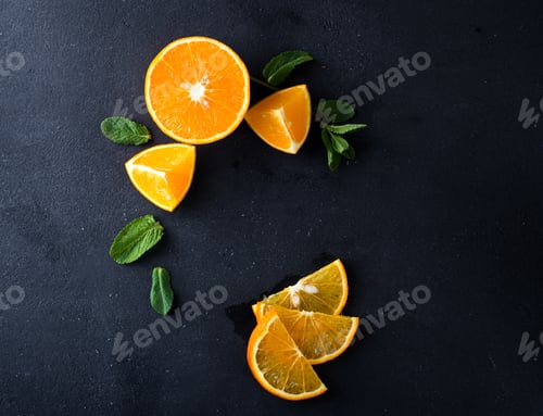 Preview: Sliced Orange and Fresh Mint Leaves on Dark Surface