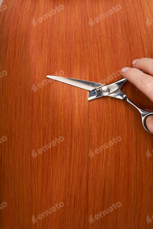 Preview: Hairdresser cuts long red hair with scissors